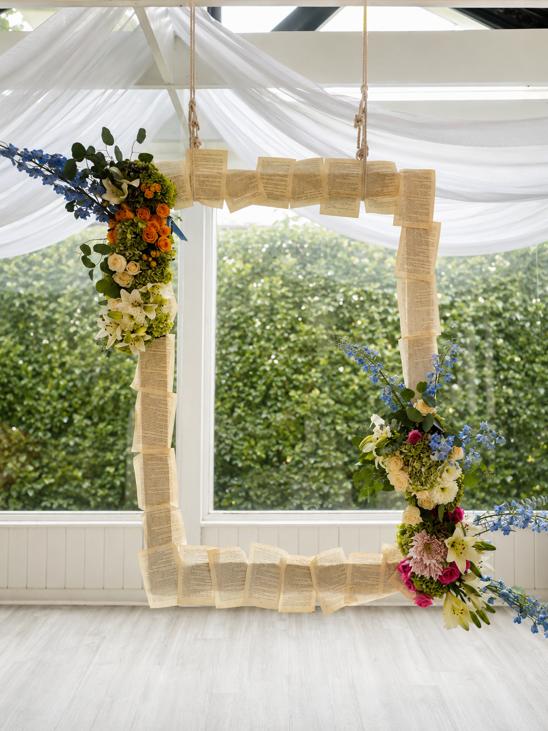 Hanging book-page photo frame decorated with cascading flowers